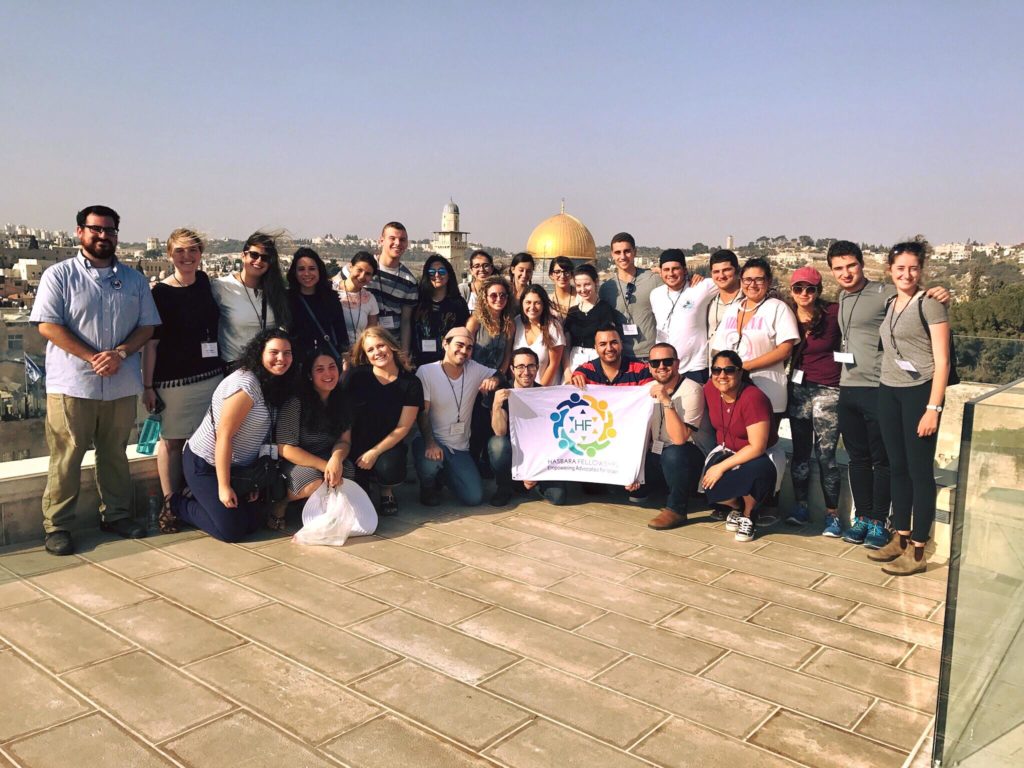 American College students in Israel pose with Hasbara Fellowships banner