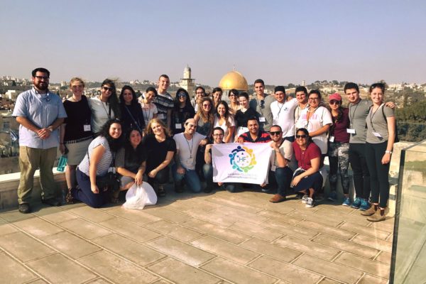 American College students in Israel pose with Hasbara Fellowships banner